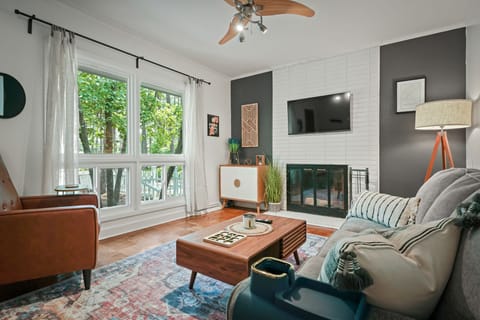 Living room with full size couch, recliner. Games and books inside the cabinet. 