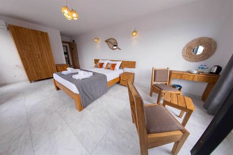 Deluxe Room with Partial Sea View | Free minibar items, desk, laptop workspace, soundproofing