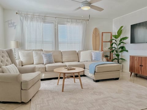 Bright living room with comfy seating and 55 inch smart tv