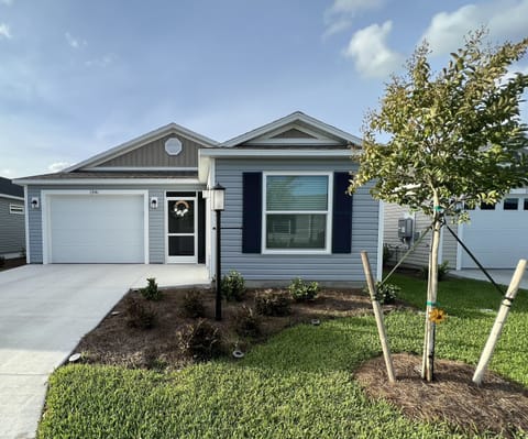 1 Car garage with golf cart garage.  Side patio with grill. Privacy wall 