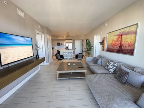 Bright living room with balcony access and city views.
