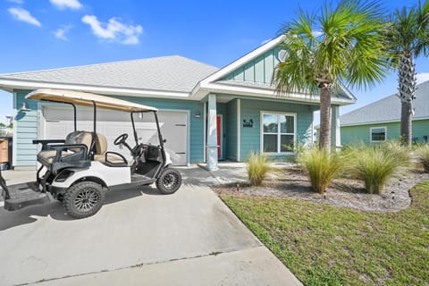Charming coastal cottage with golf cart included for easy beach access and neighborhood exploration.