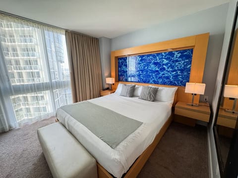 Spacious bedroom with large bed and plenty of natural light.