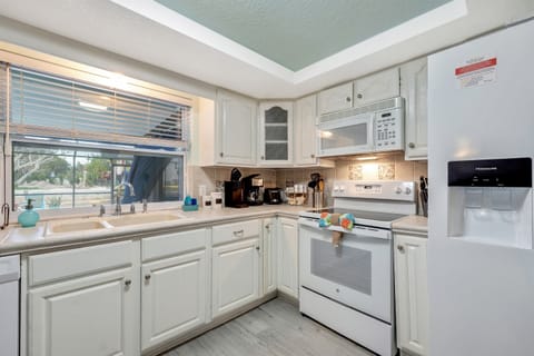 The contemporary design is complemented by top-of-the-line appliances, ensuring that every cooking endeavor is met with efficiency and style.