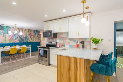 Open concept kitchen with all the utensils, pots, pans, blender, rice maker, toaster, etc you would expect to be able to cook a great meal for your family and friends! 2 dining rooms and bar-top seating can accommodate your entire group!