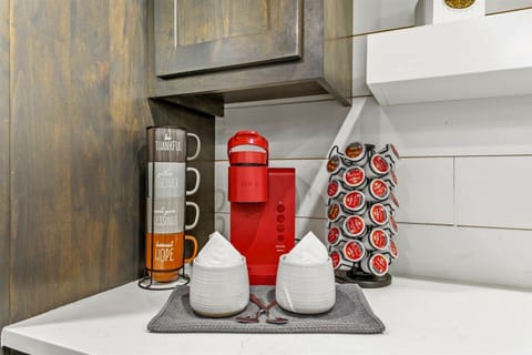 Start your day in our cozy coffee nook featuring a stylish red Keurig and a variety of coffee choices.