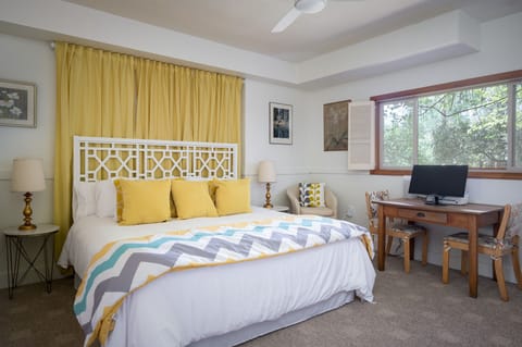 Extra large king bedroom with seating and work area.