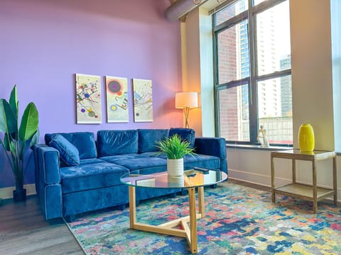 Spacious living room with a lot of natural light and large windows.
