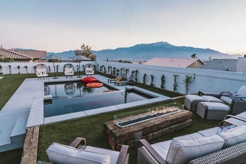 Large pool with 20-person hot tub, gas fireplace and mountain views.