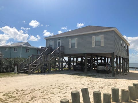 Waterfront property elevated on stilts with covered parking below and easy beach access steps away from your door.