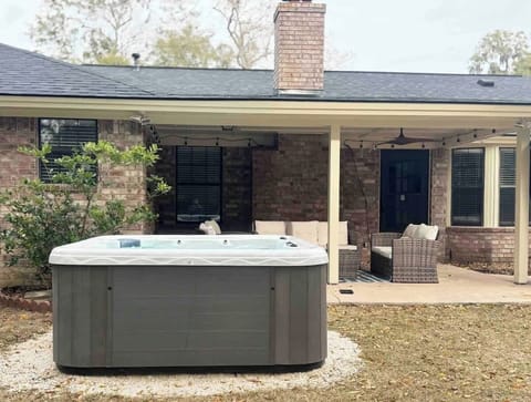 In addition to this hot tub, the property also boasts a fire pit and a cozy outdoor seating area. 
