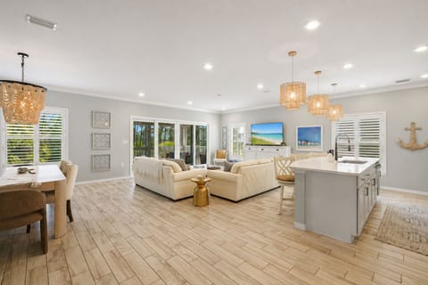 Relax in this bright open-concept coastal retreat featuring designer furnishings, airy interiors, and a spacious layout perfect for family vacations and beach getaways.