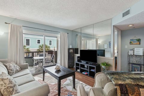 Open Living Area with Balcony Access at Down by the Sea, a beachfront Sand Dollar Villas vacation condo.