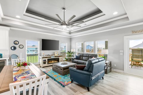 Open living room, dining, kitchen. Enjoy natural light, view and 70" Roku TV.