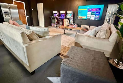 The ultimate entertainment space with a variety of arcade games, board games, and a TV perfect for a movie marathon. Cozy couches and a stylish wood-finish table, and a double-door fridge for your snacks and drinks - perfect room for endless fun.