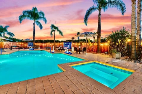 Your private resort complete with pool basketball and volleyball nets, this underwater-lit pool and jacuzzi, bult amidst terra cotta pavement, warm string lights, and palm trees add a touch of tropical charm for unforgettable evenings.
