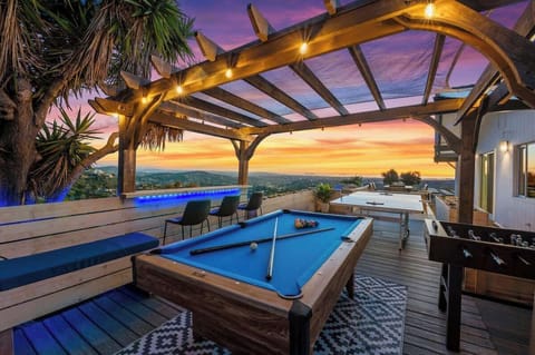 Unwind at this stunning San Diego deck, complete with a pergola, cozy seating, and games like pool and foosball. Enjoy vibrant sunsets and panoramic views for the ultimate evening retreat.