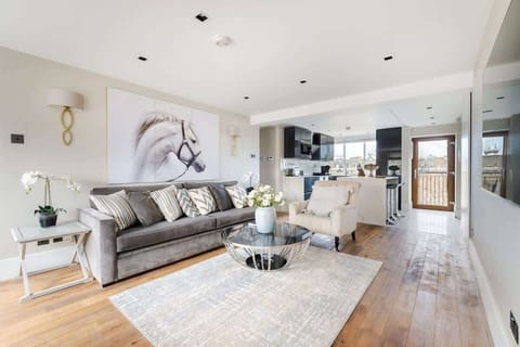 Living Room | Experience the epitome of luxury in our spacious living room, seamlessly integrated with an open-plan kitchen. Enjoy the grandeur of a 55-inch TV while staying comfortably cool with the air conditioning.
