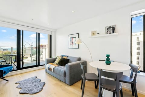 The lounge part of this room has a large flat screen TV and a covered balcony.