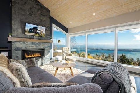 Living room with gas fireplace and large windows with view