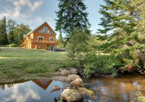 Outside view of cottage, yard and river