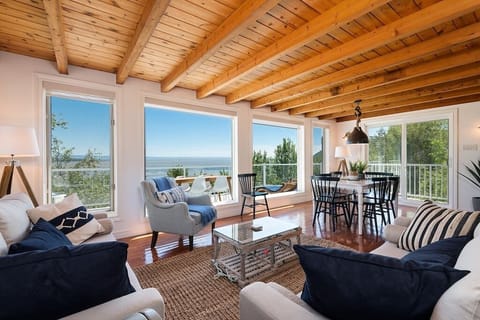 Living room and dining area with large windows