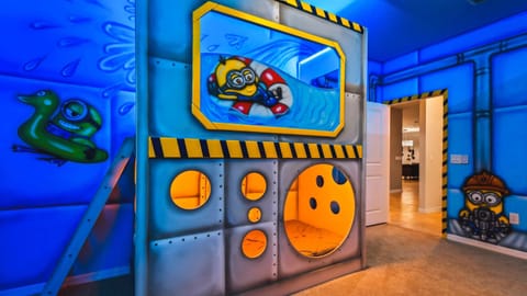 Minions-themed bunk room with bright murals and cozy pods for a fun-filled stay.