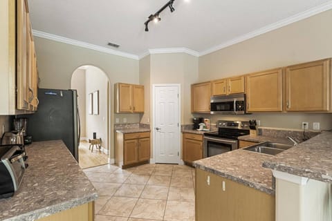 The kitchen area is a culinary haven, boasting ample counter space for easy meal preparation. Equipped with modern amenities.