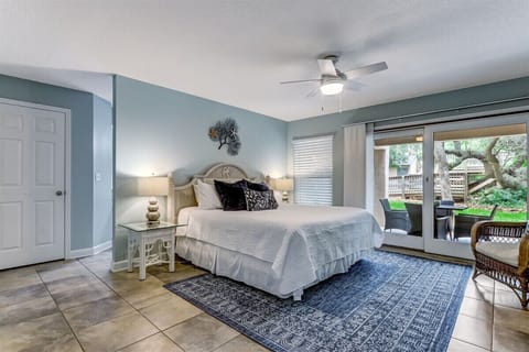 King size bed with sliding glass doors that lead to the oversized back patio.