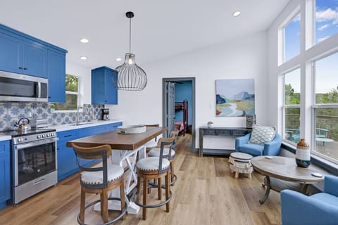 View looking right from the entry door.  The cabin features an open floor plan with kitchen, dining, and seating in the same room.