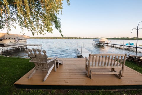 Your private lakefront deck awaits with Adirondack chairs perfect for morning coffee and peaceful evening reflections over the water.