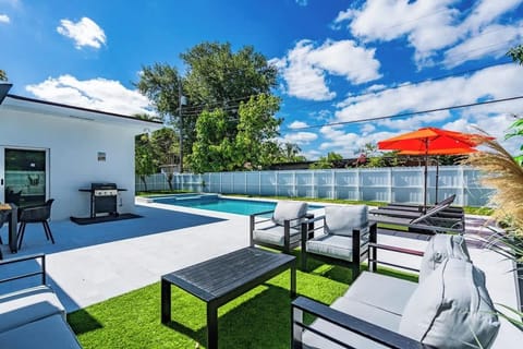 Outdoor Oasis: Relax by the poolside grill with vibrant seating and sunlit skies!