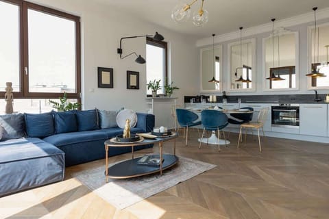 Living room with a sofa, TV, kitchenette and exit to the terrace.