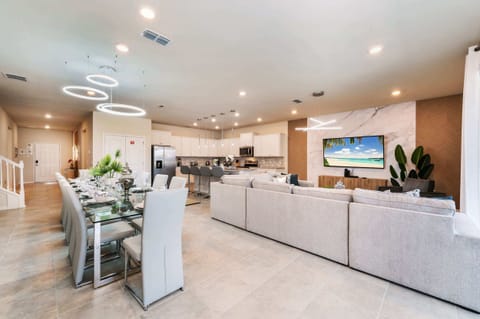 Elegant open-plan living and dining area with modern amenities, perfect for entertaining large groups.