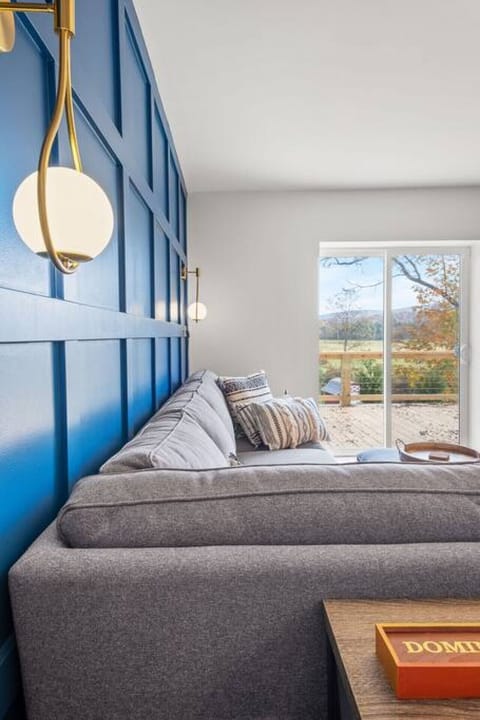 Dramatic accent colors and mid-century modern lighting sets the tone for elegant, yet comfortable gatherings, in the main living area, renovated from top to bottom.