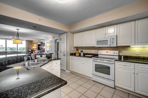 Bright kitchen with bar seating and classic white cabinetry