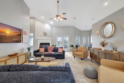 Adding a touch of natural warmth, you'll discover wooden accent console tables and cabinets scattered strategically throughout the room.