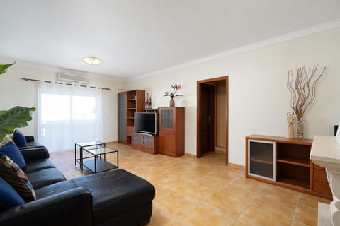 Our lovely living area with a sofa, A/C, and cable TV #cozy #home #comfort #decoration