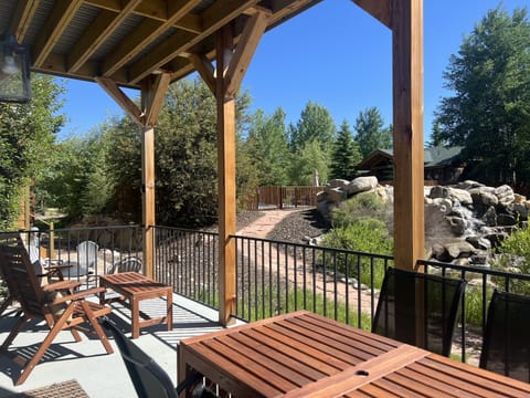 Back deck view towards neighborhood pool & waterfall. Table expands to seat 10