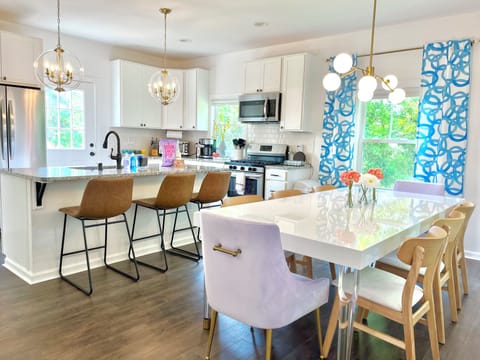 The perfect space to entertain! The dining table seats 8, 3 additional barstools, and everything you'd need to cook a standard meals and get your morning coffee fix.