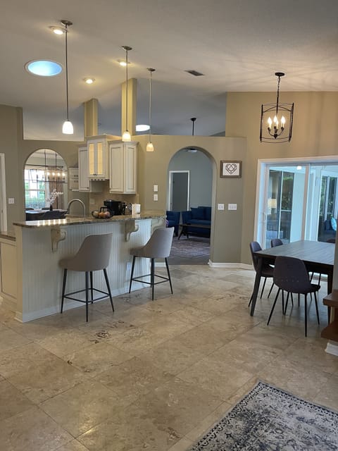 fully equipped kitchen , seating at bar and dining table 