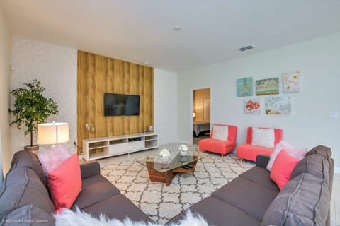 Gather in the inviting living room with comfortable furnishings, a large flat-screen TV, and complimentary high-speed Wi-Fi for entertainment and relaxation.