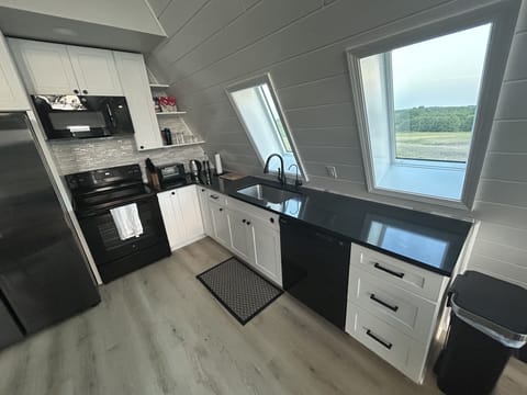 Full-size kitchen stocked with appliances, cookware, dishes, and RO filter