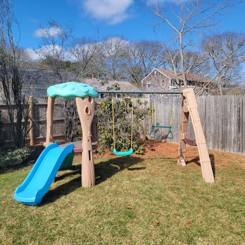 fenced-in yard with playground 