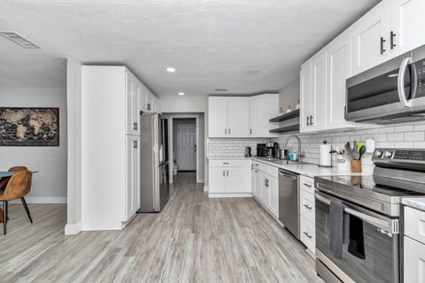 Upgraded kitchen, wine/coffee nook, recessed lights, newer appliances, pots/pans