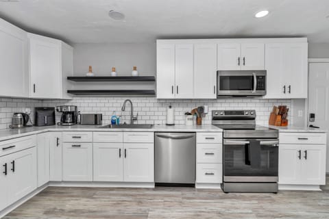 Upgraded kitchen, wine/coffee nook, recessed lights, newer appliances, pots/pans