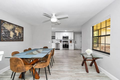 Dining room by kitchen/family room, seating for 8, windows, ceiling fan & open