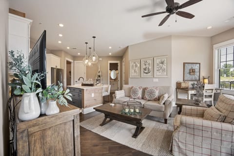 Cozy living room w/ plush seating, smartTV, workstation, downtown view.