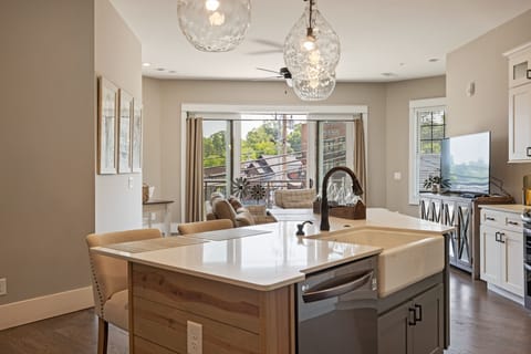 Modern open kitchen w/ stainless steel appliances & granite island seating for 4