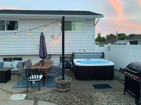 - Enjoy the private hot tub with soothing evening ambiance   - Gather around the outdoor dining table for shared meals   - Fire up the gas grill for a family barbecue under string lights  